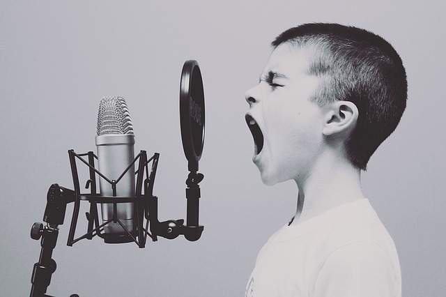 A child shouting at a studio microphone