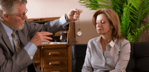 A mature woman gets hypnotized by her therapist.